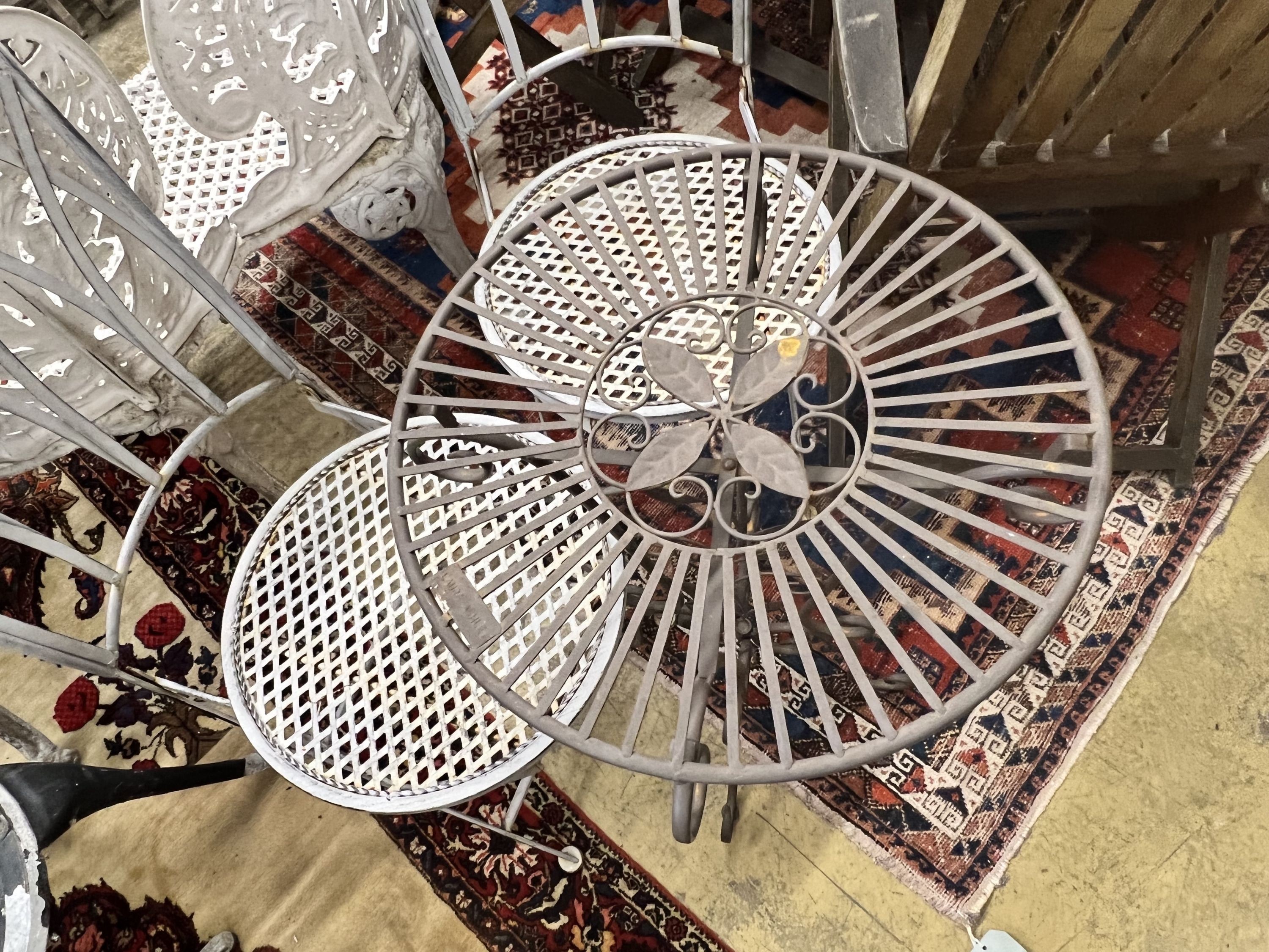 A Laura Ashley circular metal garden table, diameter 43cm, together with two folding garden chairs